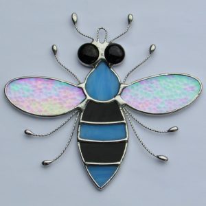 Stained glass Bee with iridescent wings, black and blue body and black eyes